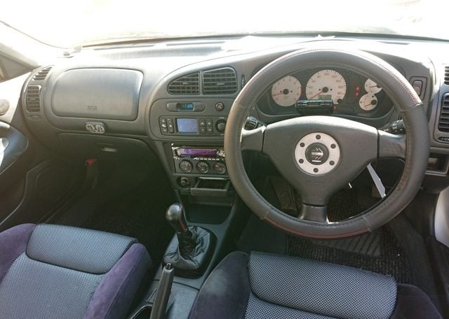 Used Lancer Evo for import from Japan via Japan Car Direct. Interior cockpit driver side